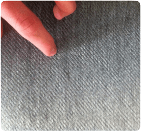 hand inspecting upholstery