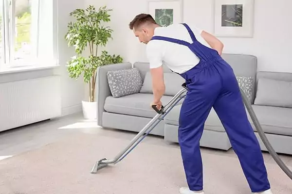 Technician using professional cleaning machine to clean a carpet